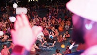 a crowd of people at a pool party